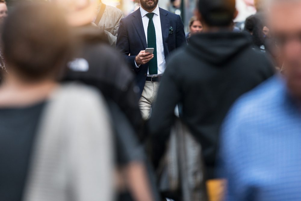 support critical communication man walking looking at cell phone