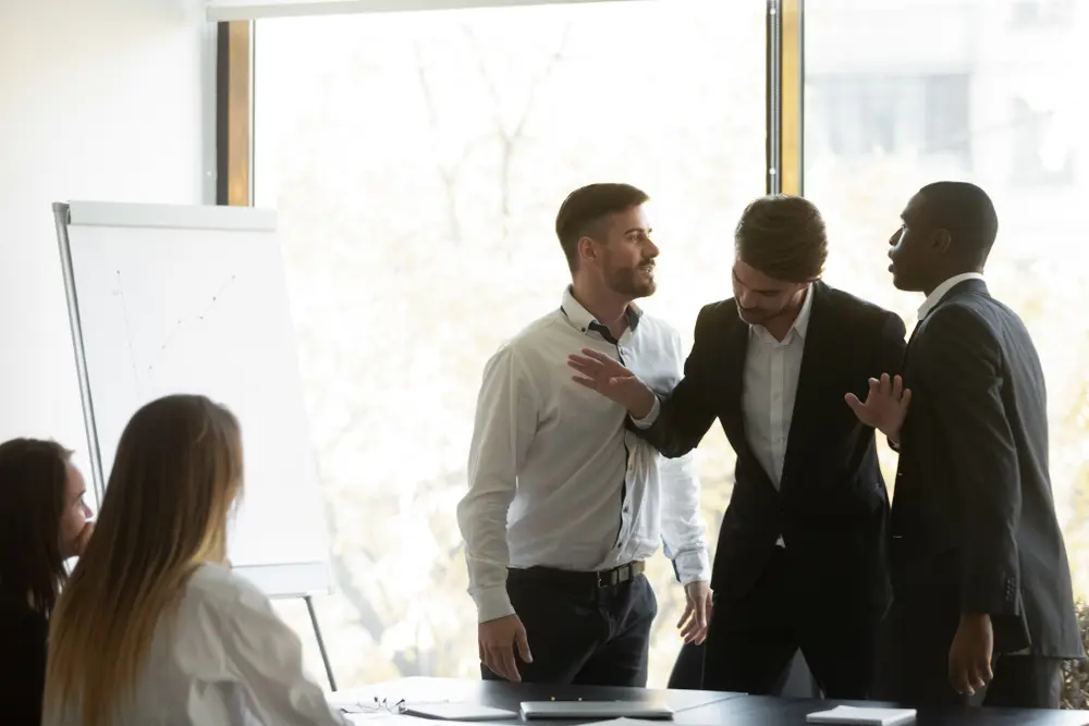 workplace violence safety plans men fighting in office with someone in between them